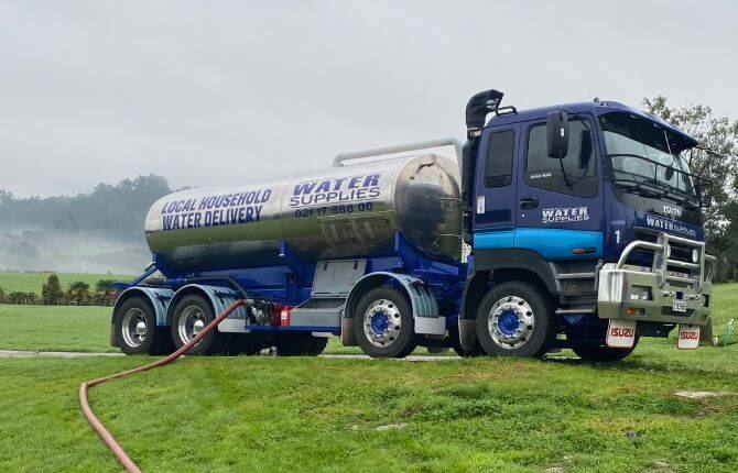 Tapped Out truck parked on rural race pumping water