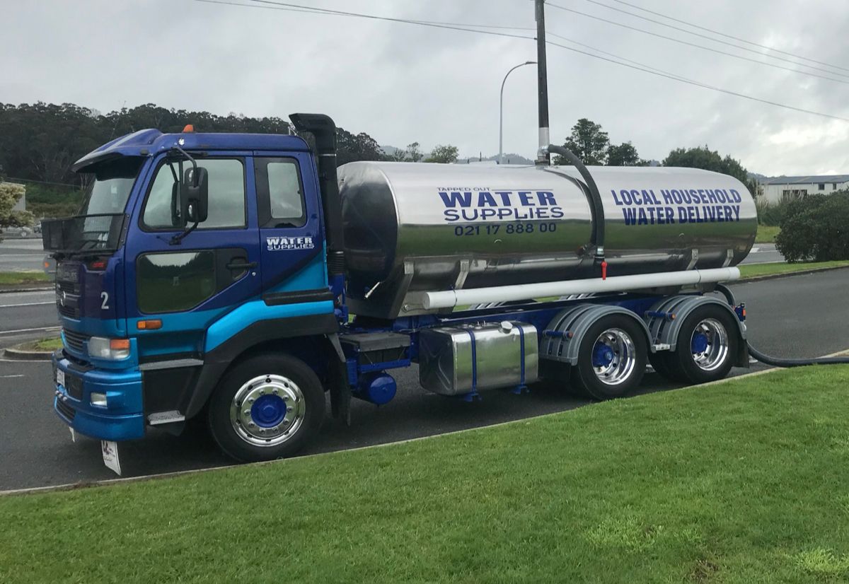 Tapped Out water truck parked showing company branding and livery